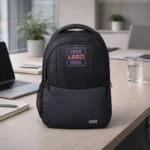 Amigo Signature Laptop Backpack 15.6 inch placed on office desk with laptop and stationery for corporate gifting and employee welcome kits