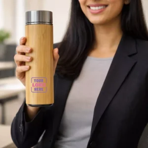 Bamboo stainless steel bottle 500 ml held in hand suitable for corporate gifting and employee onboarding kits