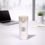 Executive coffee travel flask off white 400 ml placed on office desk suitable for corporate gifting and employee welcome kits