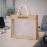 Transparent window jute bag placed on desk displaying clear front panel suitable for corporate gifting and onboarding kits