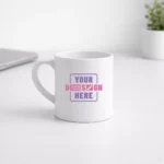 White ceramic tea mug 175 ml placed on office desk with custom print area for corporate gifting and employee welcome kits
