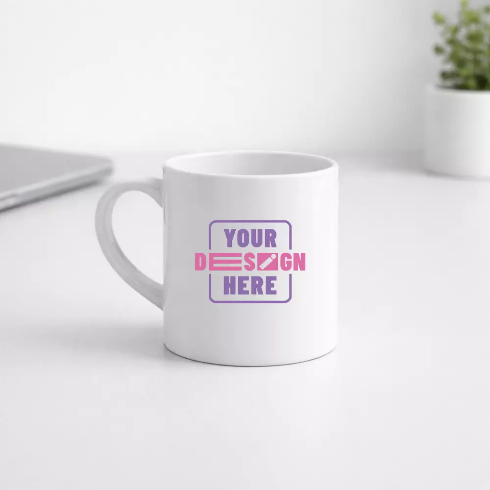 White ceramic tea mug 175 ml placed on office desk with custom print area for corporate gifting and employee welcome kits