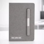 A5 navy notebook with pen slot and phone stand, ideal for corporate gifting and employee onboarding kits.